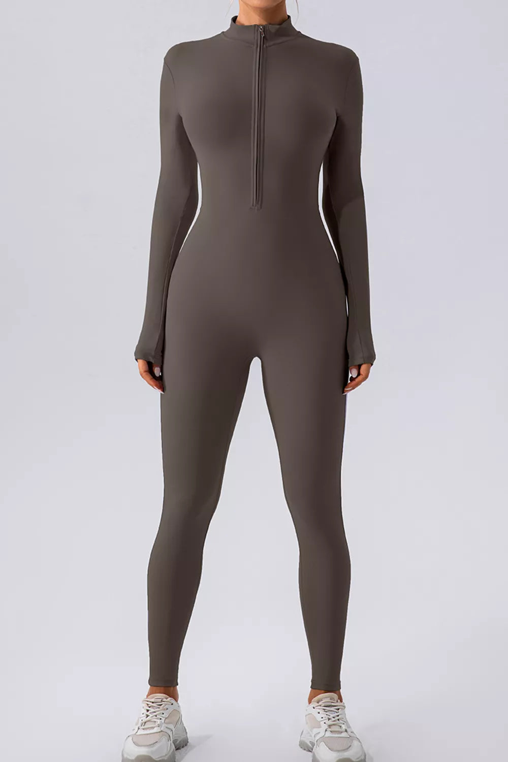 Trendsi half zip mock neck active jumpsuit in black, featuring long sleeves and fitted design for workout or athleisure wear.
