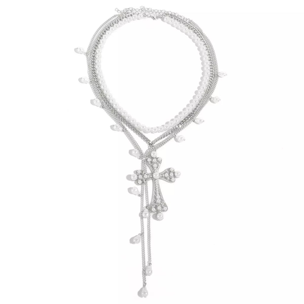 Three-piece set of pearl cross pendant necklaces featuring elegant silver chains, perfect for layered jewelry styles.
