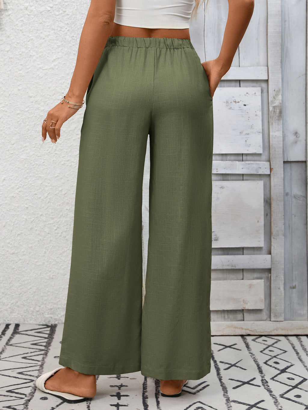 Women's high-waisted wide-leg drawstring pants in soft breathable viscose, stylish and comfortable, shown in natural fabric detail.