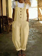 Casual button-front wide-leg overalls by Shopimist, featuring adjustable straps and roomy pant legs, styled for relaxed wear.