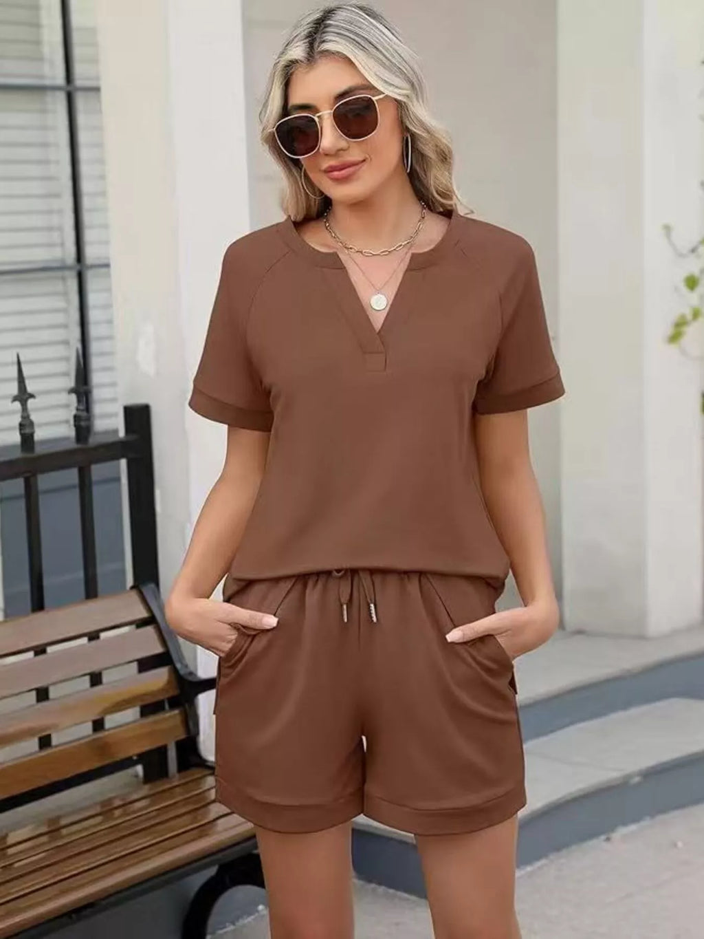 Solid color short sleeve top and shorts set by Trendsi, casual two-piece outfit for warm weather, featuring comfortable fabric and relaxed fit.