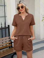 Solid color short sleeve top and shorts set by Trendsi, casual two-piece outfit for warm weather, featuring comfortable fabric and relaxed fit.