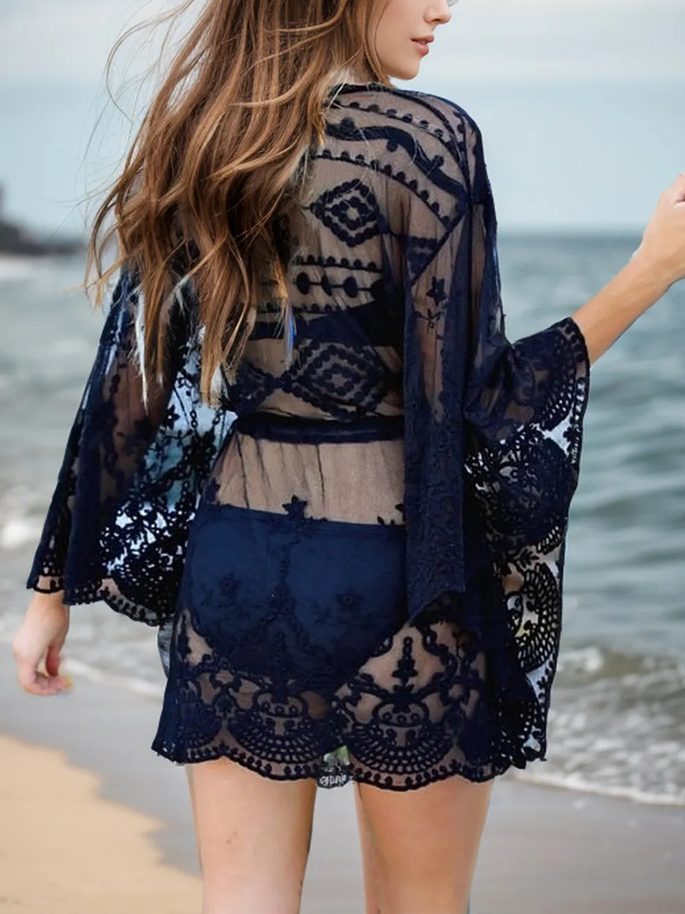 Lace V-neck three-quarter sleeve cover-up dress by Trendsi, featuring delicate lace fabric and a flattering V-neck design.