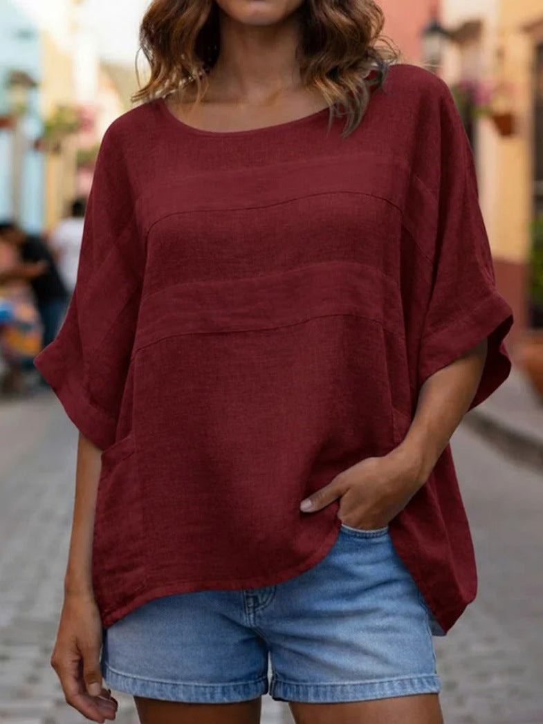Loose-fitting crew neck top with three-quarter sleeves from Plush Fashion Hub, shown in a relaxed fit and soft fabric.