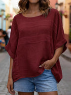 Loose-fitting crew neck top with three-quarter sleeves from Plush Fashion Hub, shown in a relaxed fit and soft fabric.