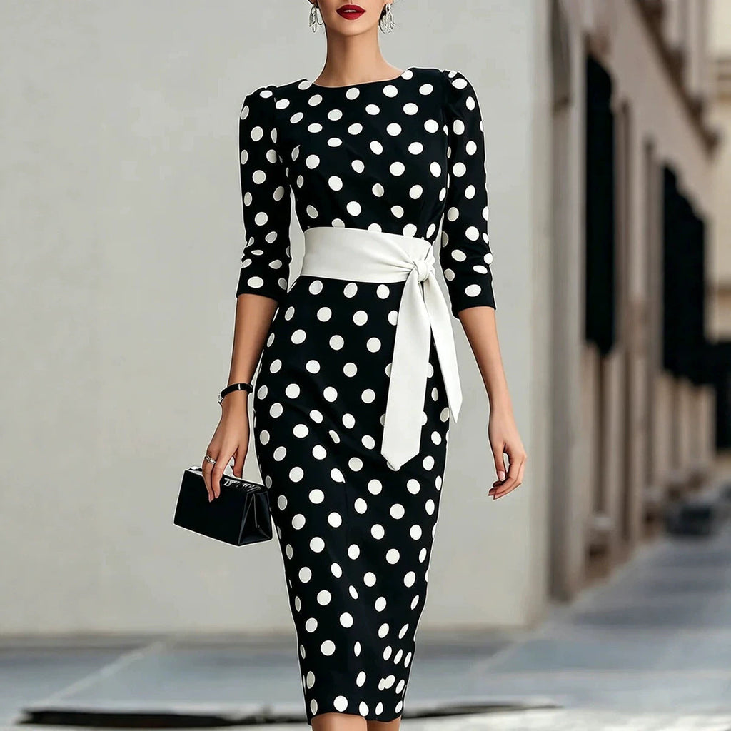 Women's retro polka-dot bodycon midi dress with belt and cross-tie detail, casualwear from FitiqueFit, shown on a mannequin.