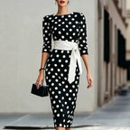 Women's retro polka-dot bodycon midi dress with belt and cross-tie detail, casualwear from FitiqueFit, shown on a mannequin.