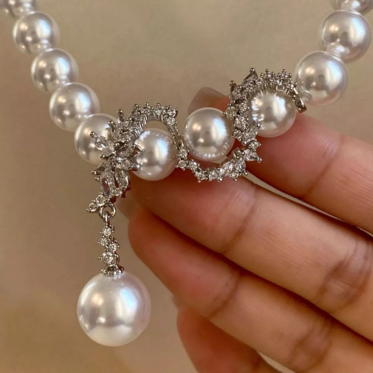Elegant zircon pearl necklace from Shopimist featuring lustrous pearls and sparkling zircon stones on a delicate chain.