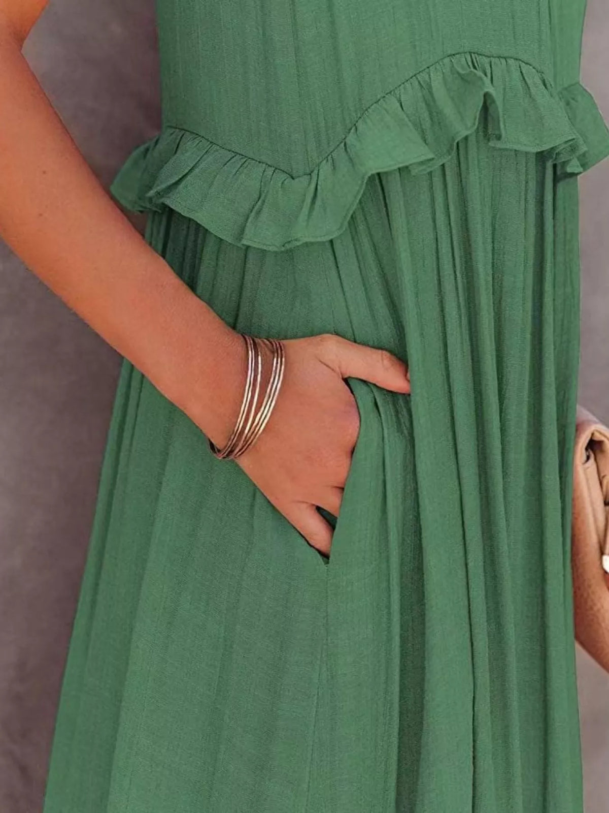 Sleeveless ruffled tiered maxi dress by Plush Fashion Hub featuring flowing fabric and layered design.