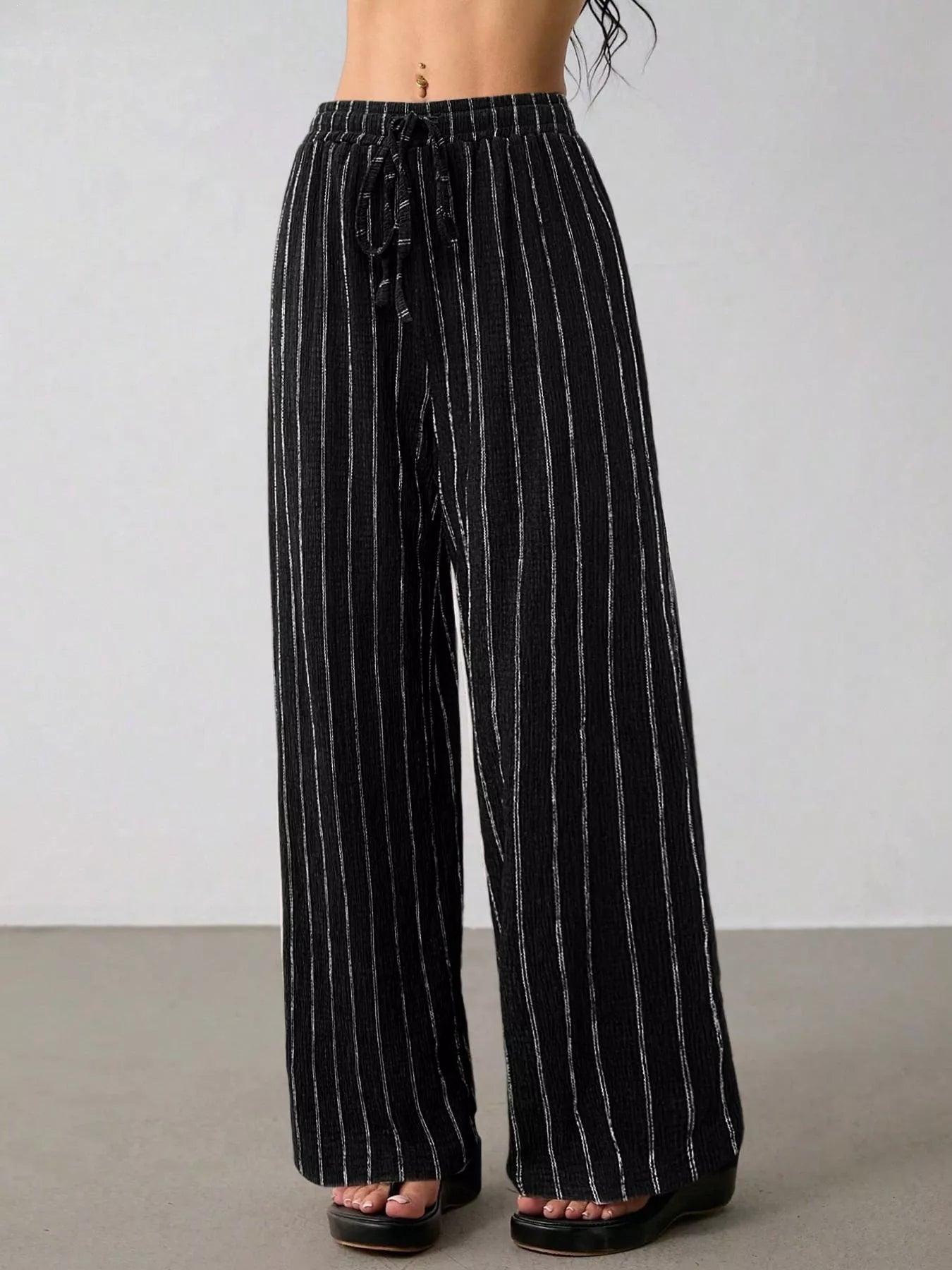 Striped wide-leg drawstring pants from Trendsi with a relaxed fit, featuring bold horizontal stripes and a comfortable waist.