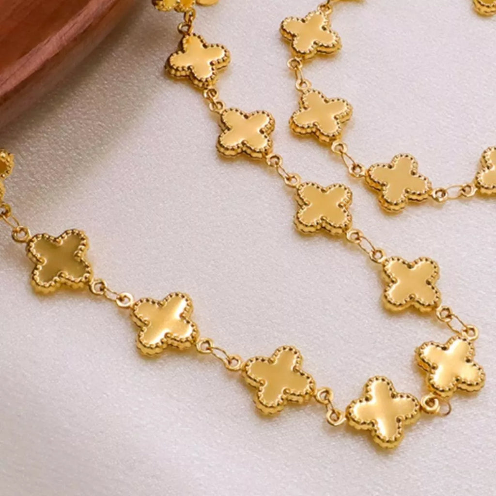 18K gold-plated clover charm necklace with delicate chain, showcasing a shiny four-leaf clover pendant for a stylish accessory.
