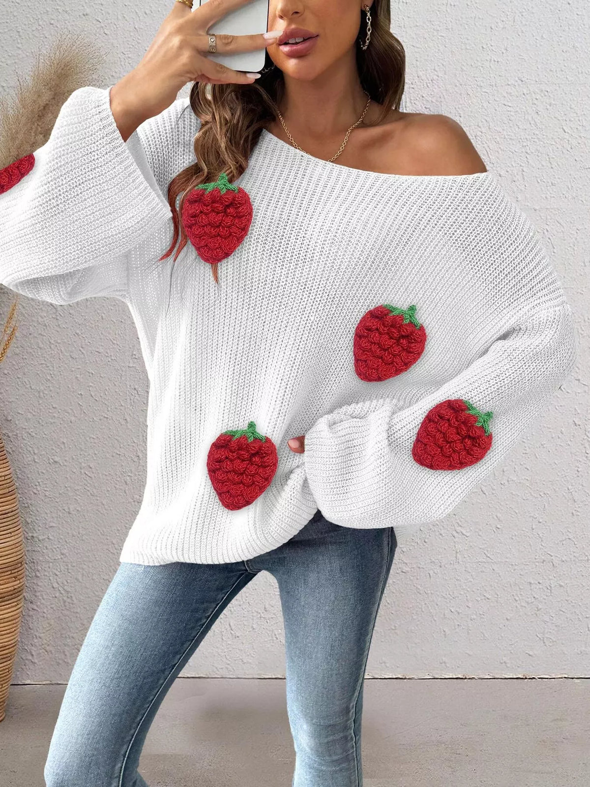 Oversized strawberry applique sweater from Trendsi, featuring colorful strawberry designs on a cozy, casual sweater.