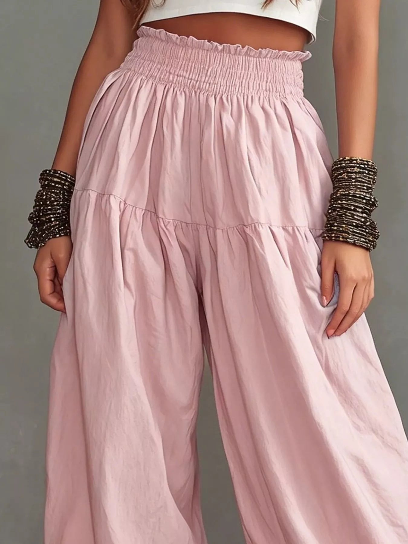 Plus size wide-leg pants with smocked waist and ruffle hem from Trendsi, featuring a relaxed fit and flowy fabric.