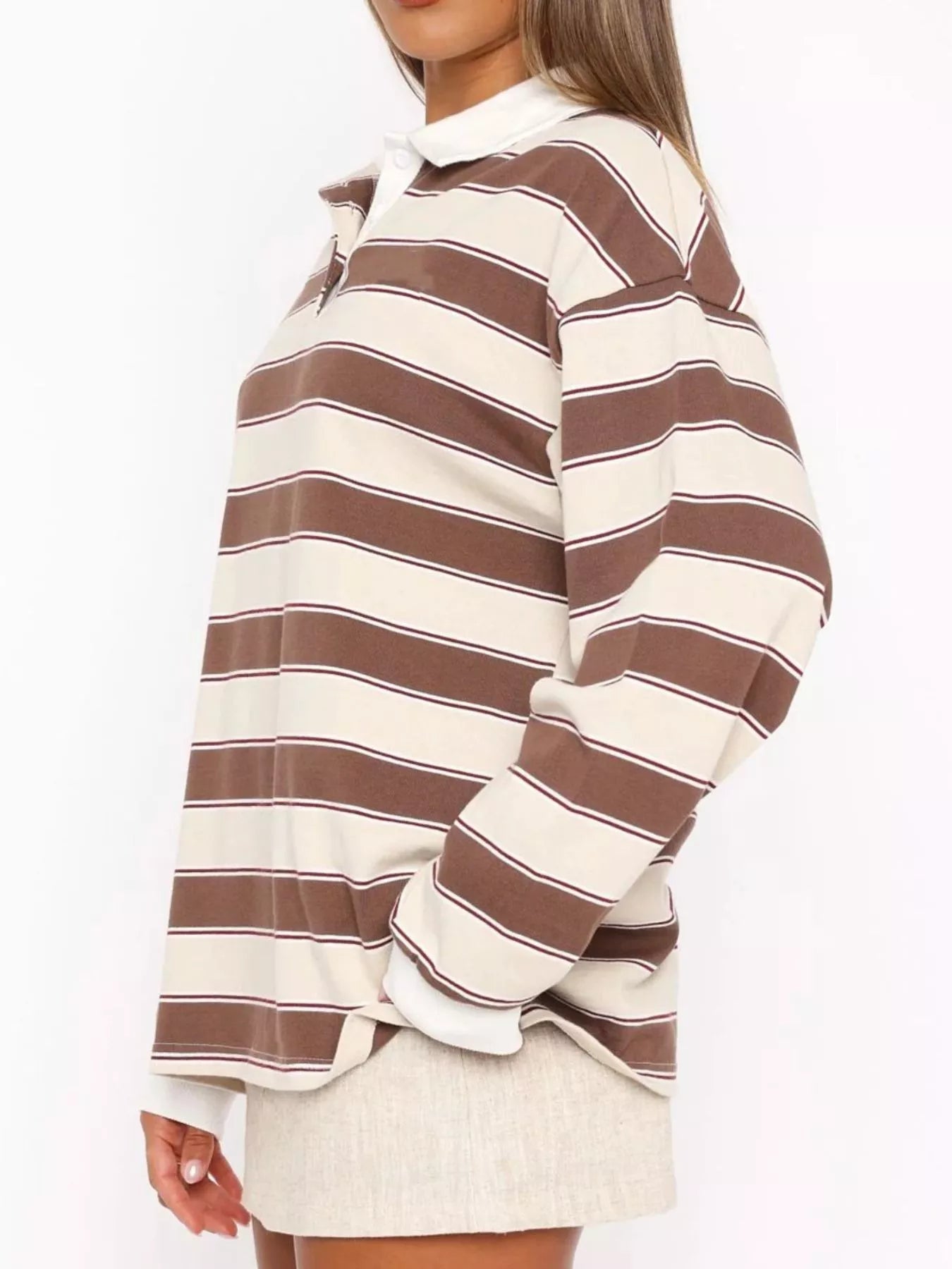 Striped long sleeve polo top with button details from Trendsi, featuring a classic collar and stylish pattern.