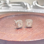 Sterling silver stud earrings with 1 carat moissanite gemstones, featuring a simple and elegant design.