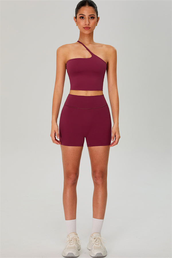 Fitglutes activewear set featuring a one-shoulder crop top and matching shorts for workout and gym use.