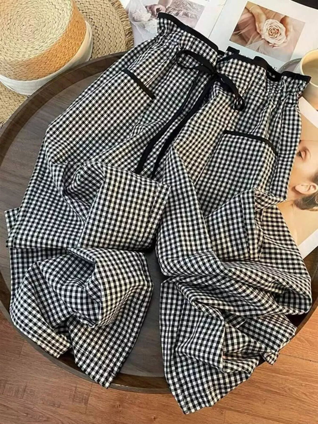 Women's high-waisted gingham wide-leg pants with pockets from Trendsi, featuring a stylish pattern and relaxed fit.
