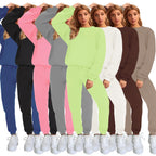Women's solid color round neck pullover sweatshirt and pants set by Plush Fashion Hub, casualwear ensemble shown in the image.