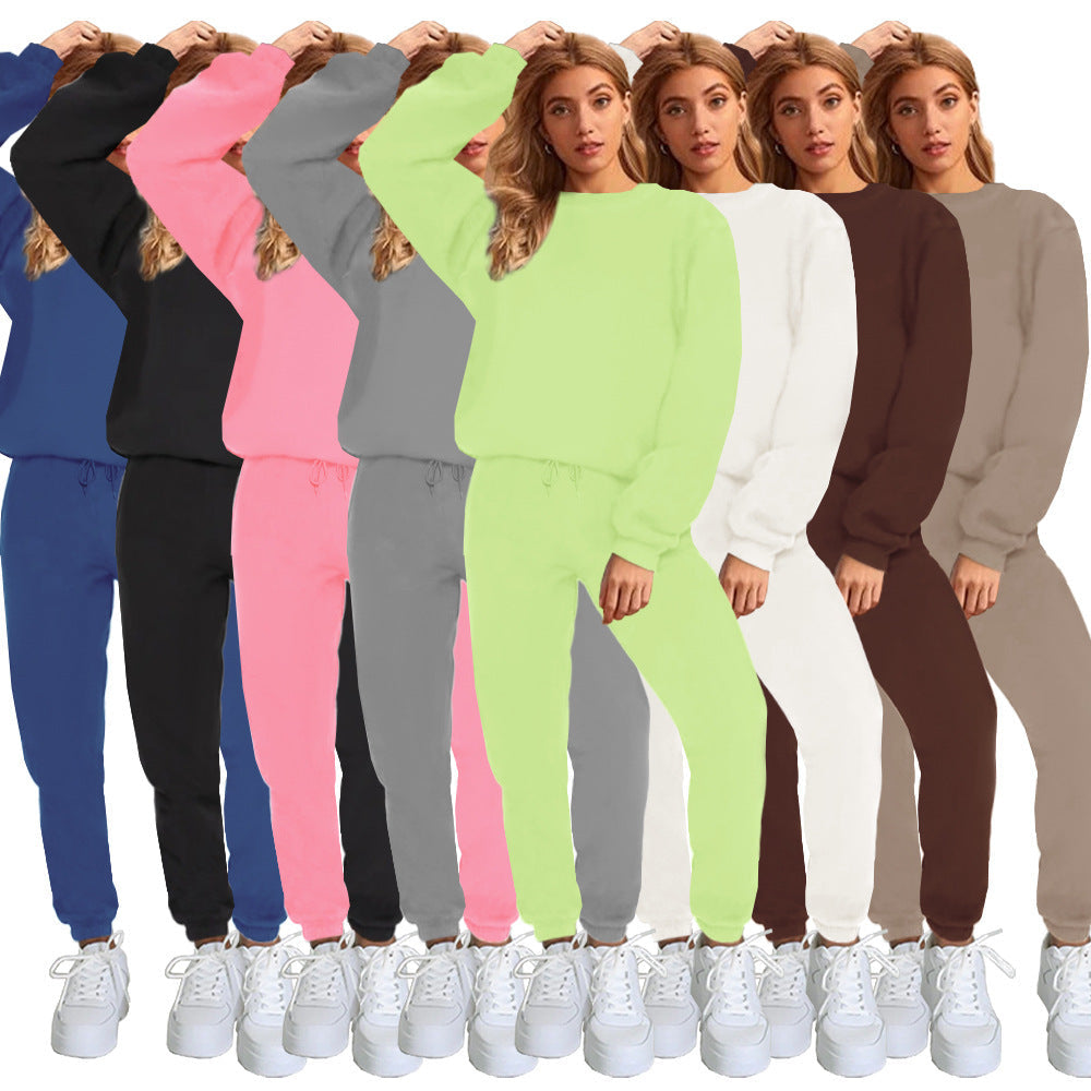 Women's solid color round neck pullover sweatshirt and pants set by Plush Fashion Hub, casualwear ensemble shown in the image.