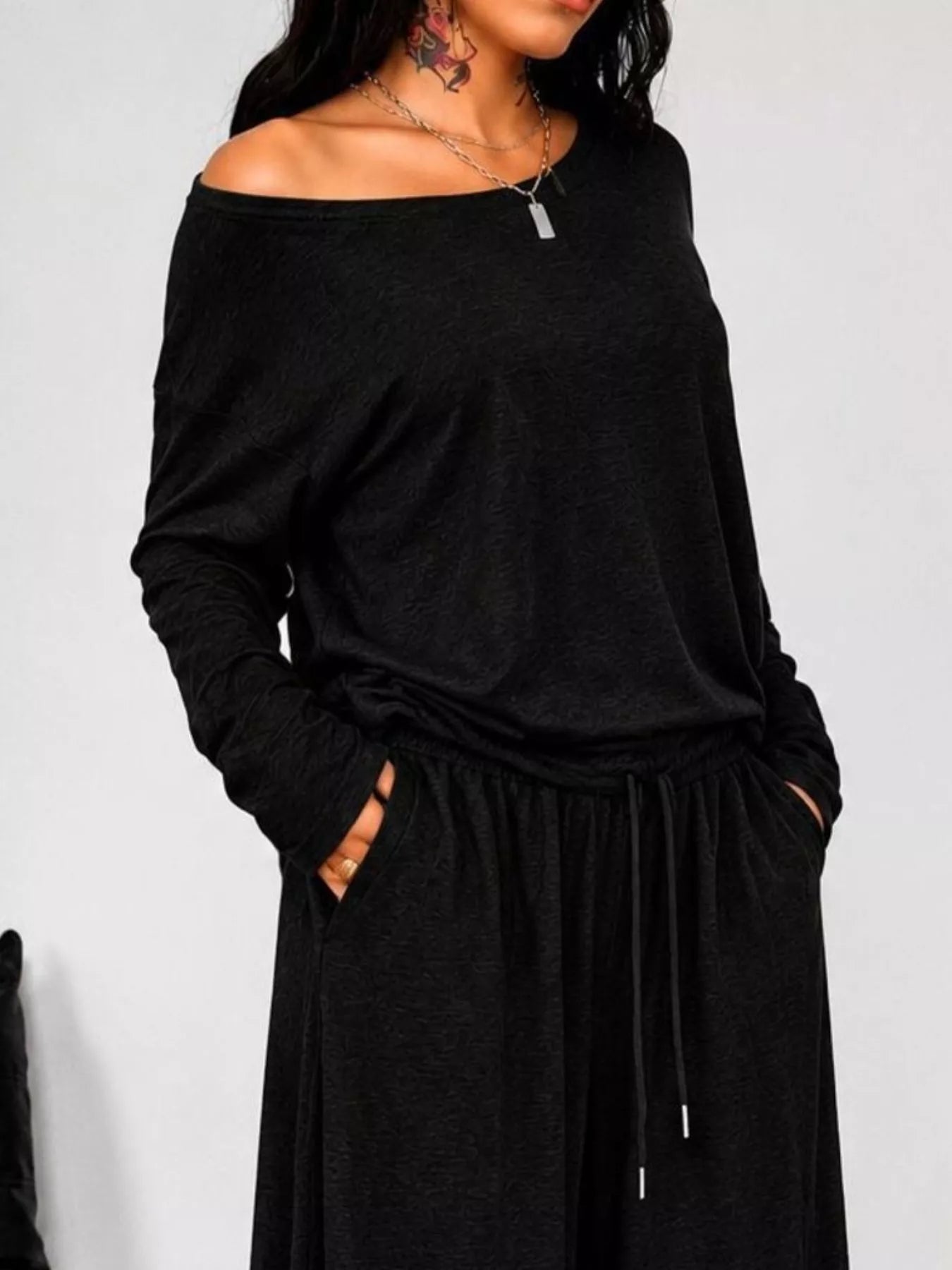 Plus size loose fit one-shoulder T-shirt and pants set by Trendsi, featuring comfortable, relaxed-fit pants in a full-size casual style.