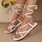 Shopimist lace-up flat sandals with open toes and ankle ties, featuring a stylish and comfortable design for warm weather wear.