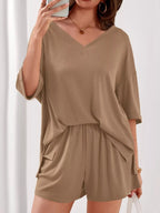 Women's casual V-neck top and shorts set by Trendsi, solid color two-piece outfit, displayed on a model.