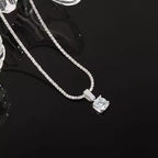 Sterling silver moissanite necklace with 1 carat center stone, showcasing elegant jewelry design and sparkling gemstone detail.