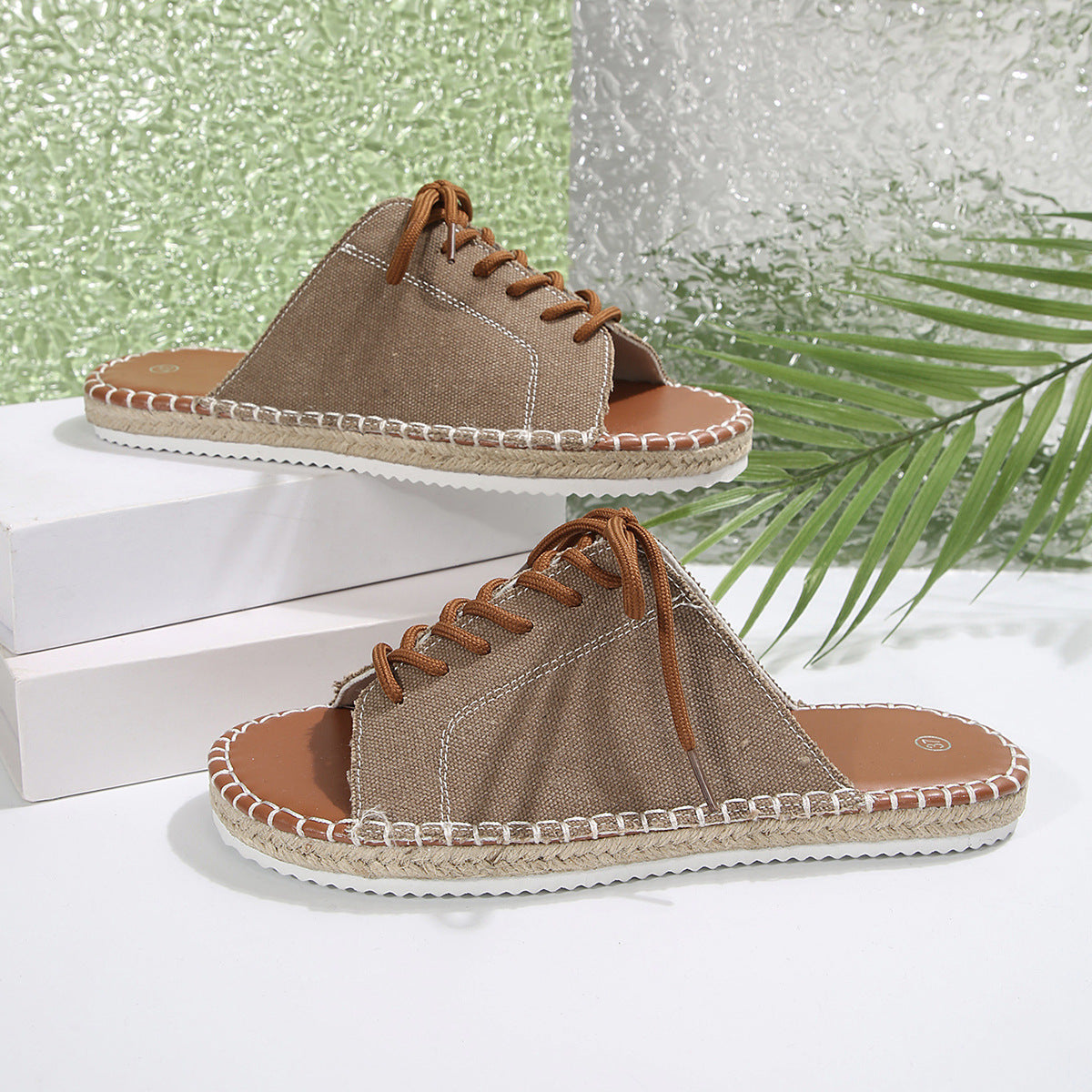 Women's lace-up open toe flat sandals in faux leather with ankle ties, stylish and comfortable footwear by Trendsi.