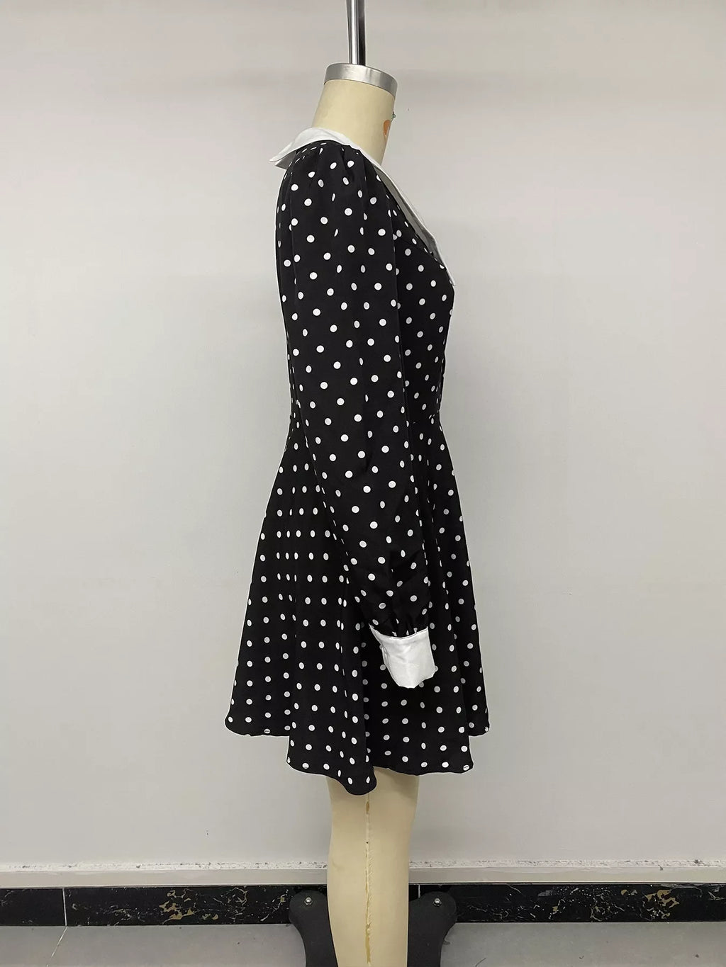 Polka dot Peter Pan collar dress by Shopimist featuring a classic design with a rounded collar and playful black and white polka dots.