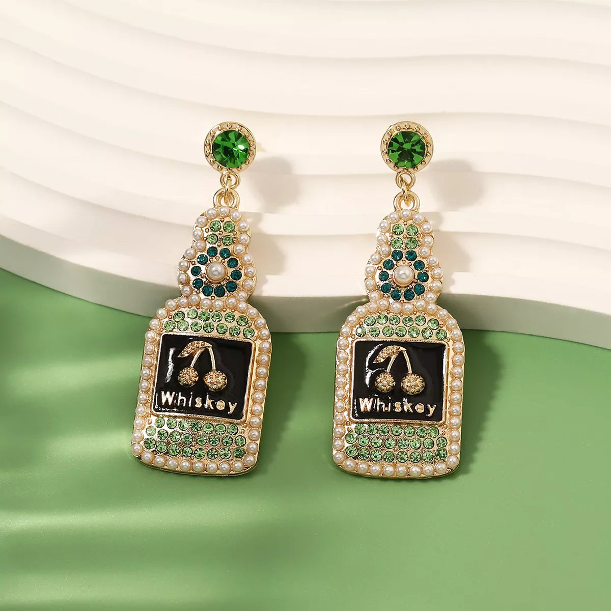 Whiskey bottle dangle earrings by Plush Fashion Hub featuring metallic whiskey bottle charms for stylish accessories.