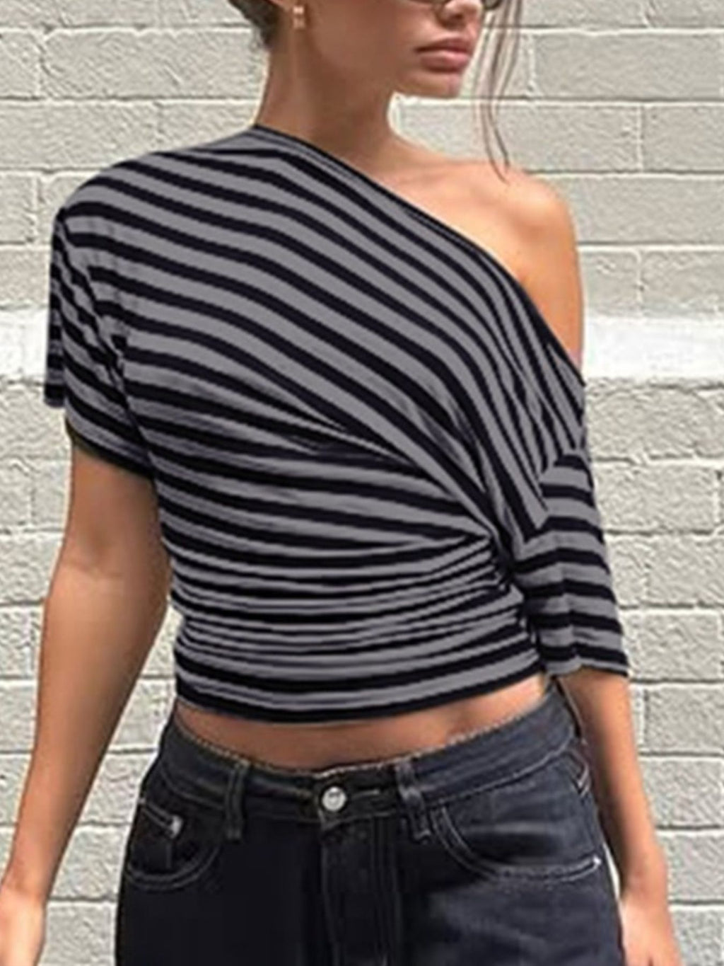 Women's chic striped one-shoulder T-shirt by Trendsi featuring an asymmetrical design and comfortable fit.