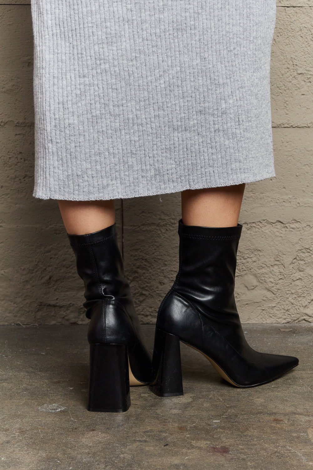 Weeboo Stacy block heel sock boots featuring a sleek design, black fabric, and a sturdy chunky heel for stylish comfort.
