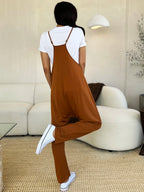 Women's sleeveless V-neck wide-leg jumpsuit with pockets, trendy women's apparel in black, shown on a model.