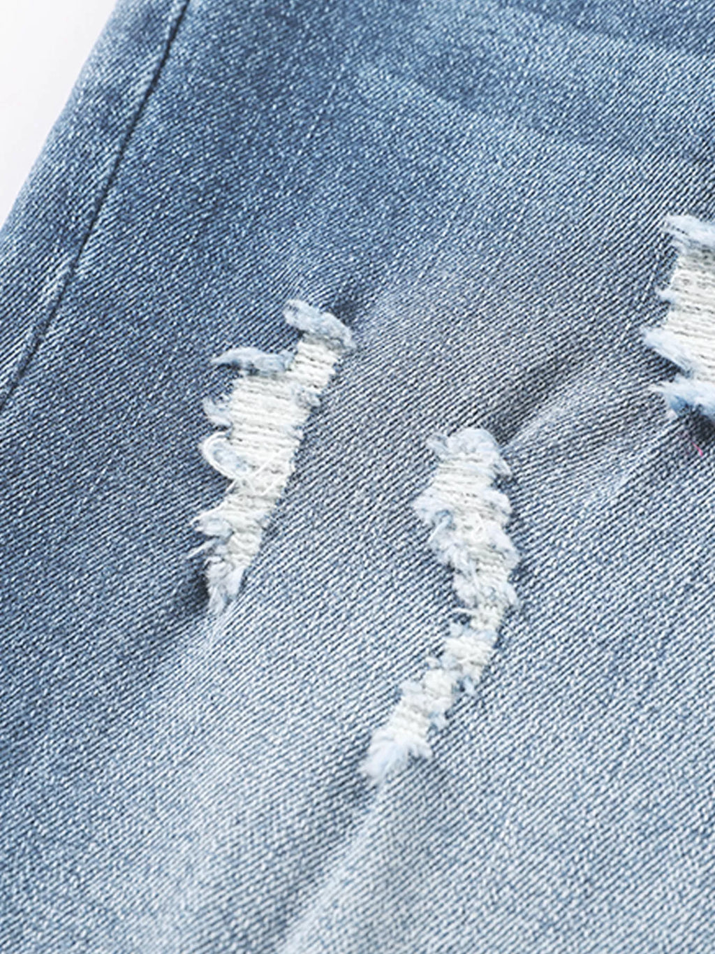Pair of high waist distressed straight leg jeans from Trendsi, showcasing their fit and trendy ripped details.
