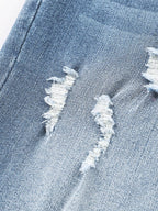 Pair of high waist distressed straight leg jeans from Trendsi, showcasing their fit and trendy ripped details.