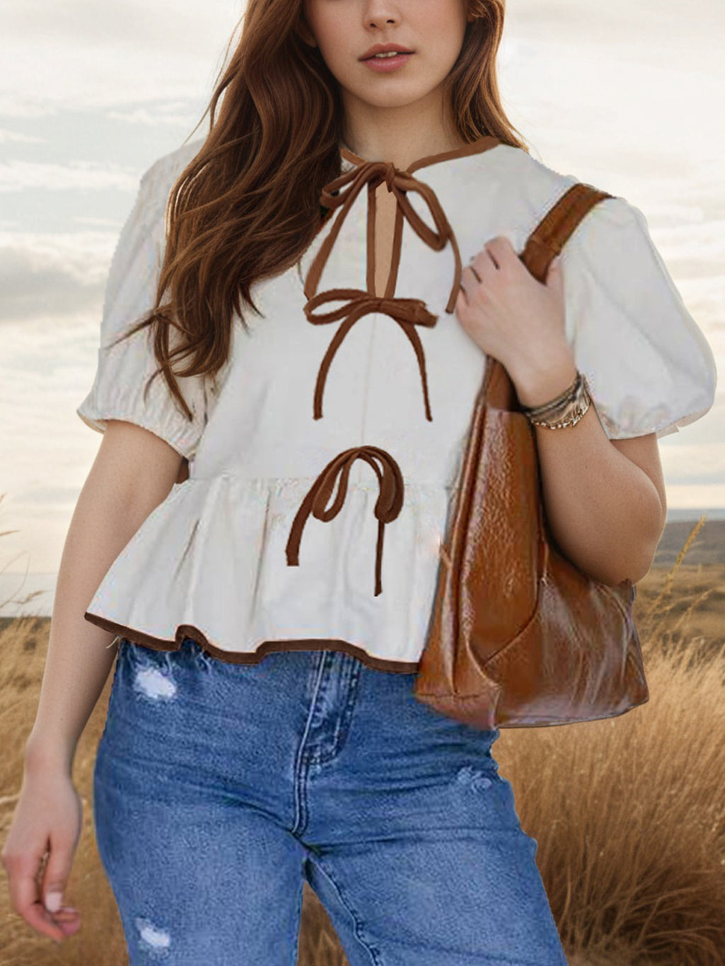 Elegant tie-front puff sleeve peplum blouse by Trendsi, featuring a stylish design and feminine details.