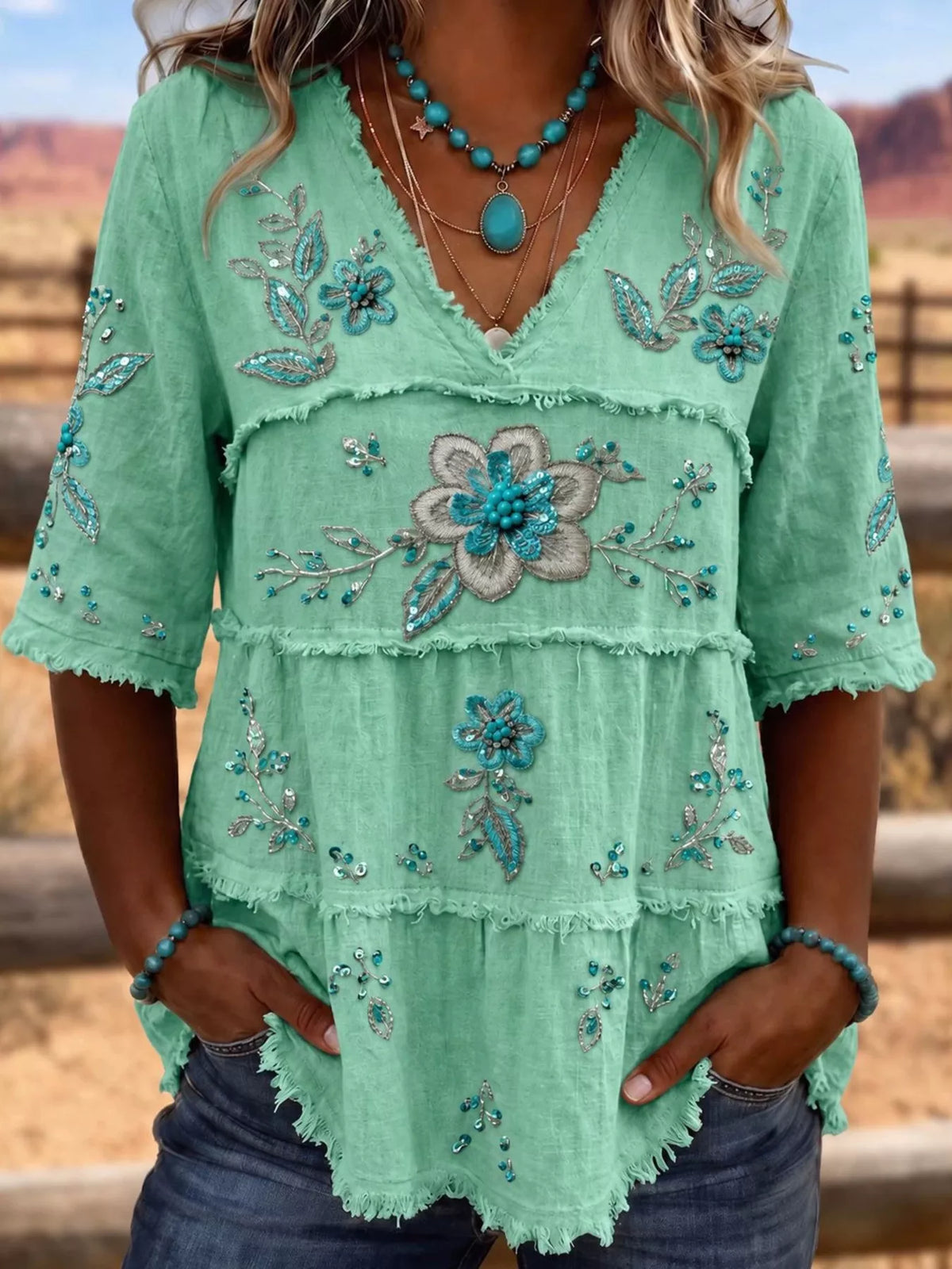 Plus size floral raw hem V-neck blouse from Trendsi, featuring a full-size shirt with a stylish floral pattern and casual V-neck design.