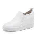Elevated slip-on women's shoes with thick soles in black, featuring a sleek design and comfortable fit by Plush Fashion Hub.