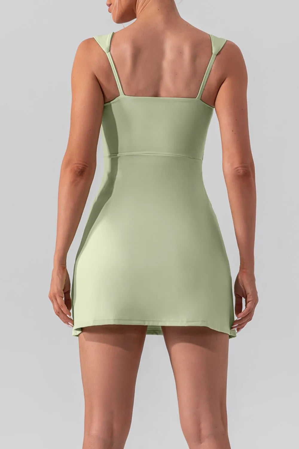 Square neck sleeveless slit mini active dress by Trendsi, shown in a stylish, fitted design suitable for activewear and casual wear.