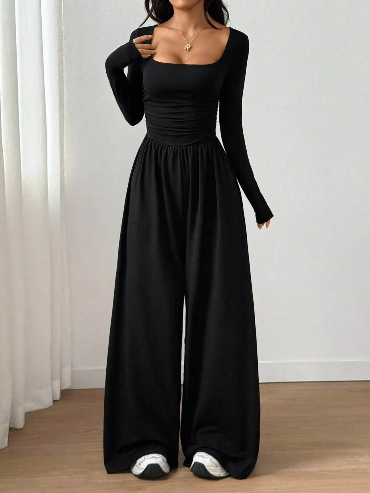 Ruched square neck wide-leg jumpsuit by Trendsi, featuring a stylish design with a fitted bodice and flowing wide-leg pants.