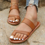 Shopimist toe loop flat sandals featuring a minimalist design with comfortable straps and open-toe style.