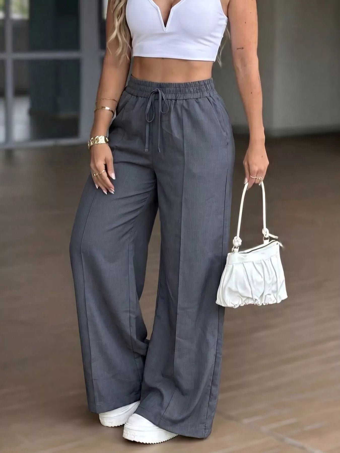 Plush Fashion Hub high-waisted wide-leg drawstring pants in soft fabric, shown on a model with a relaxed fit and casual style.