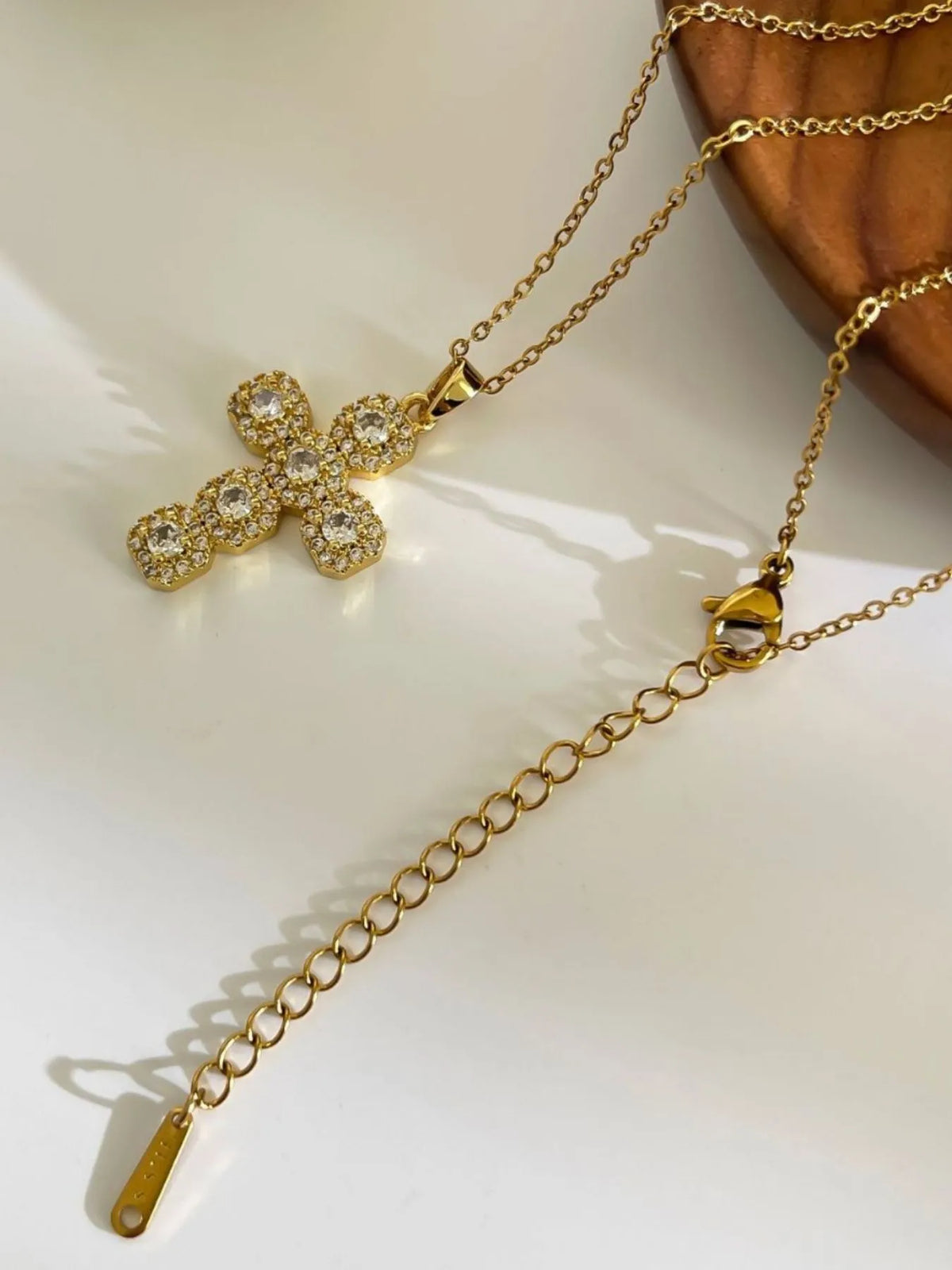 Stainless steel zircon cross necklace with inlaid stones, featuring a sleek and elegant design from Plush Fashion Hub.
