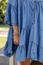 VYSN Notched Flare Sleeve Denim Dress displayed on a hanger with a close-up of the stylish sleeve details.