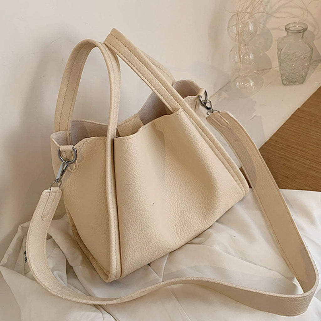 Plush Fashion Hub Kira handbag, stylish leather handbag with top handles and modern design, shown in a close-up view.