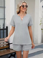 Solid color short sleeve top and shorts two-piece set by Trendsi, casual and comfortable loungewear for women.
