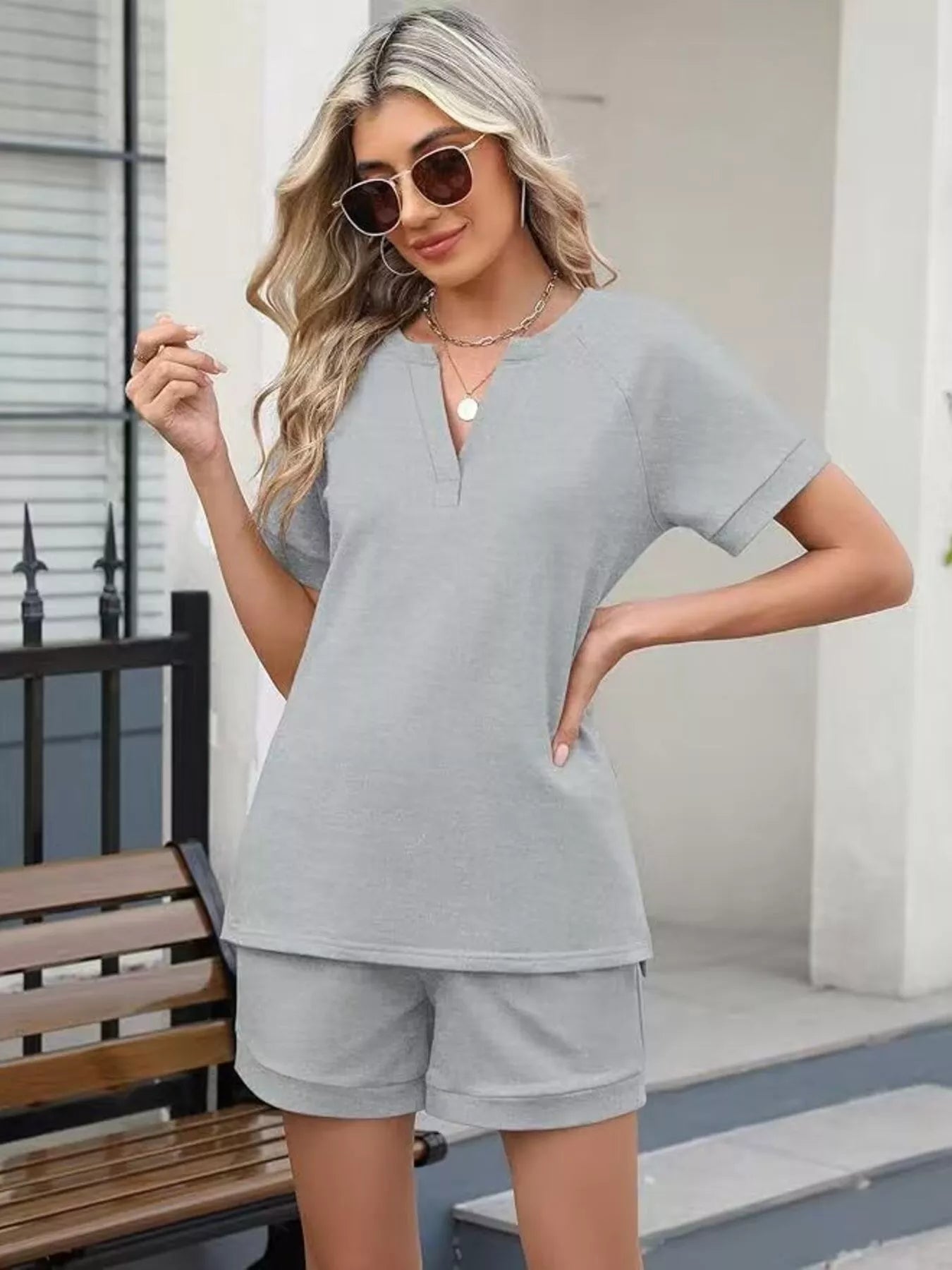 Solid color short sleeve top and shorts two-piece set by Trendsi, casual summer outfit with comfortable fabric and relaxed fit.