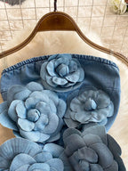 Floral applique strapless denim dress by Trendsi featuring a fitted bodice and floral embellishments, perfect for casual or summer wear.