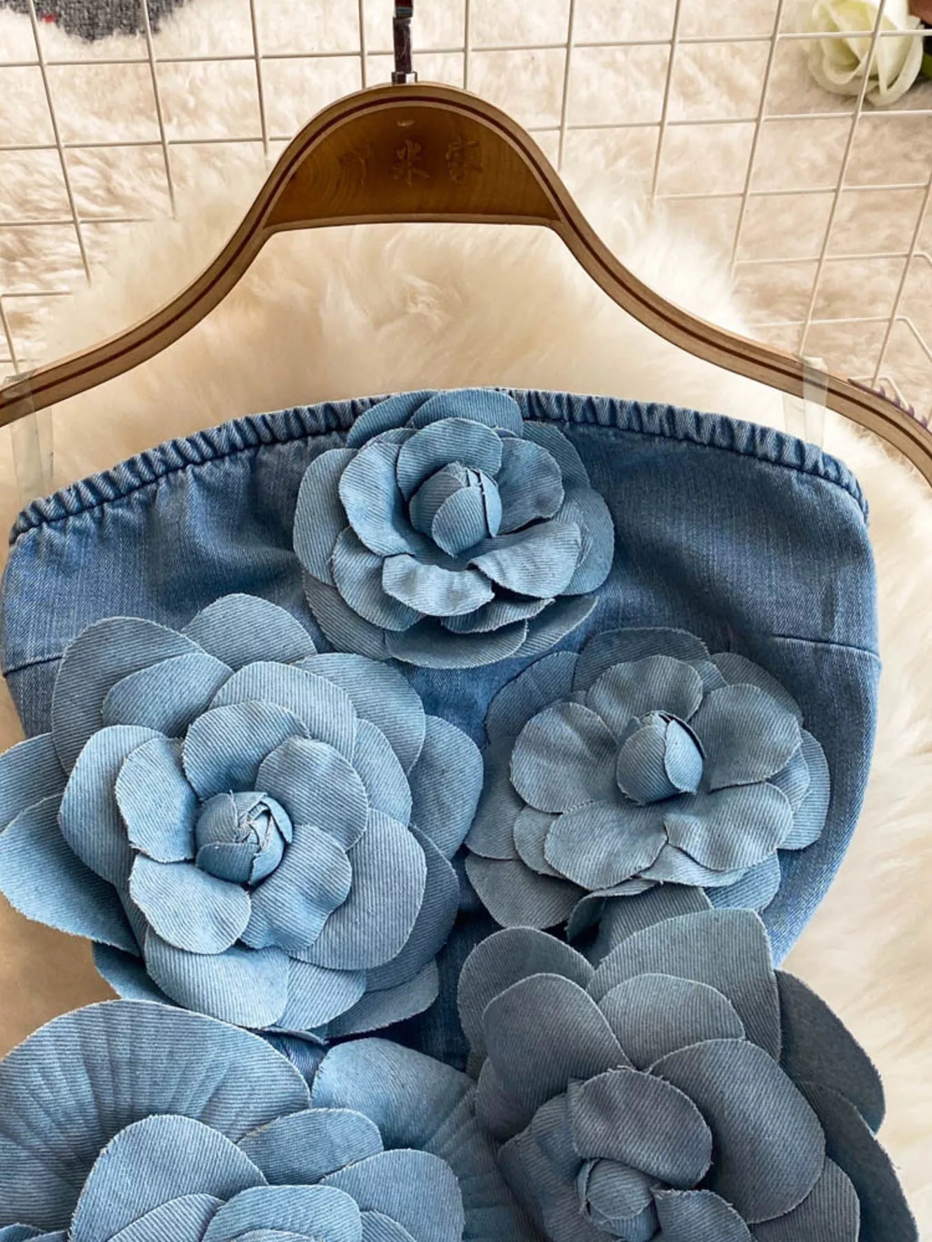Floral applique strapless denim dress by Trendsi featuring a fitted bodice and floral embellishments, perfect for casual or summer wear.