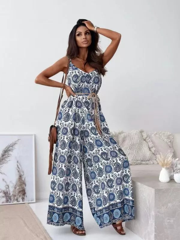 Printed spaghetti strap wide-leg jumpsuit by Plush Fashion Hub, featuring a stylish design and flowing wide-leg silhouette.